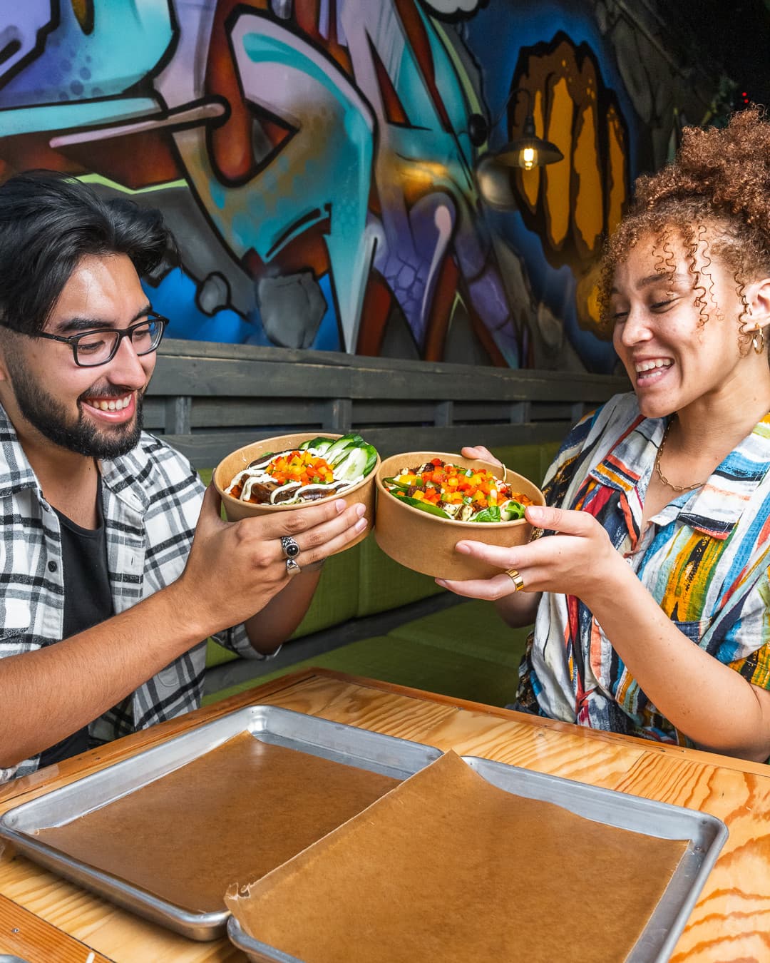 Two people enjoying STREATs bowls